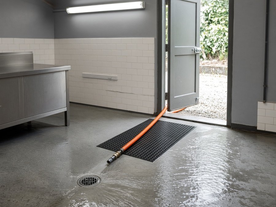 Jetter hose run from a rear door to a kitchen floor cleanout — Grease Line Hydro Jetting & Kitchen Drain Cleaning in Fullerton, CA